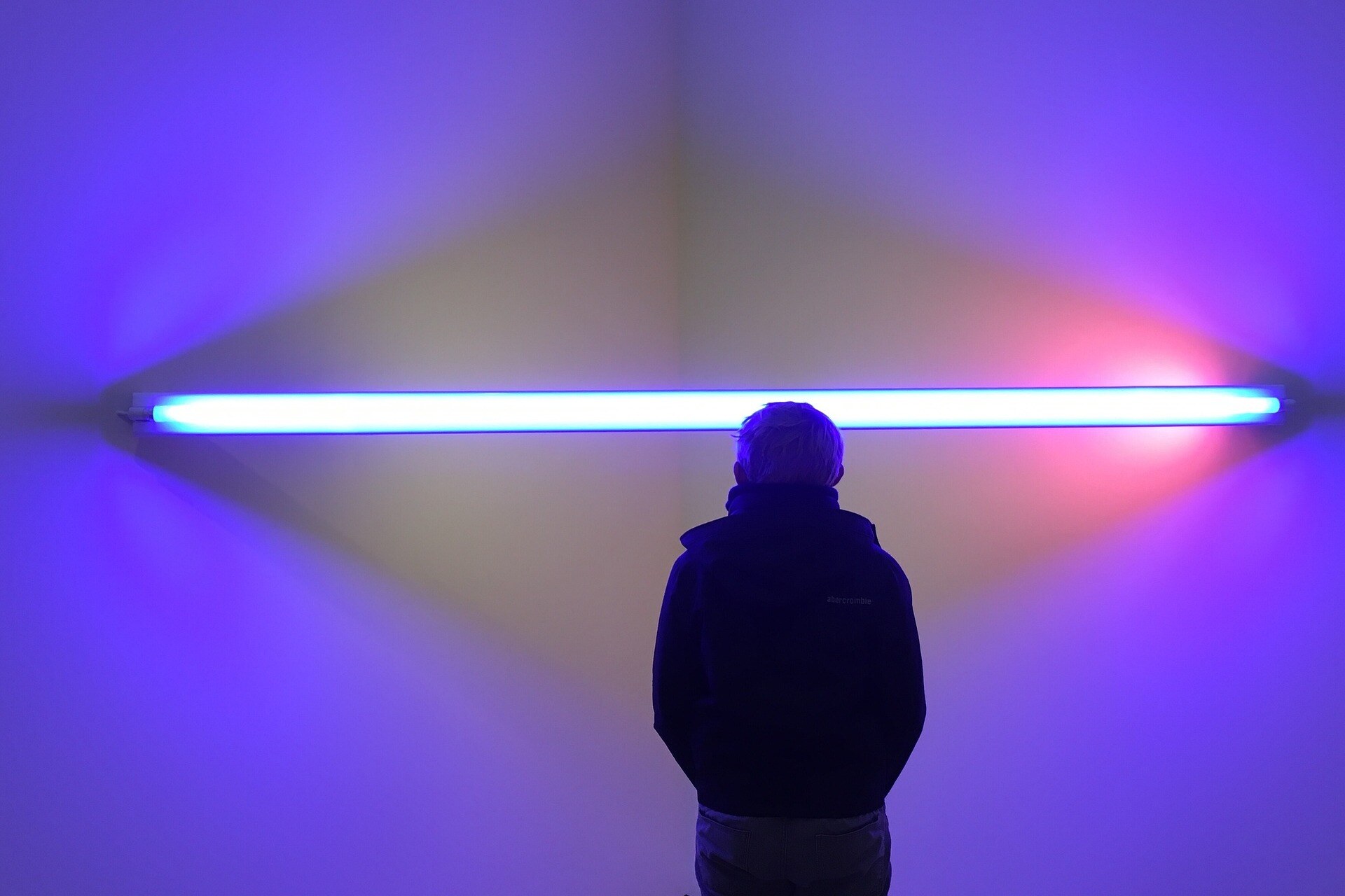 a man standing in front of the fluorescent light