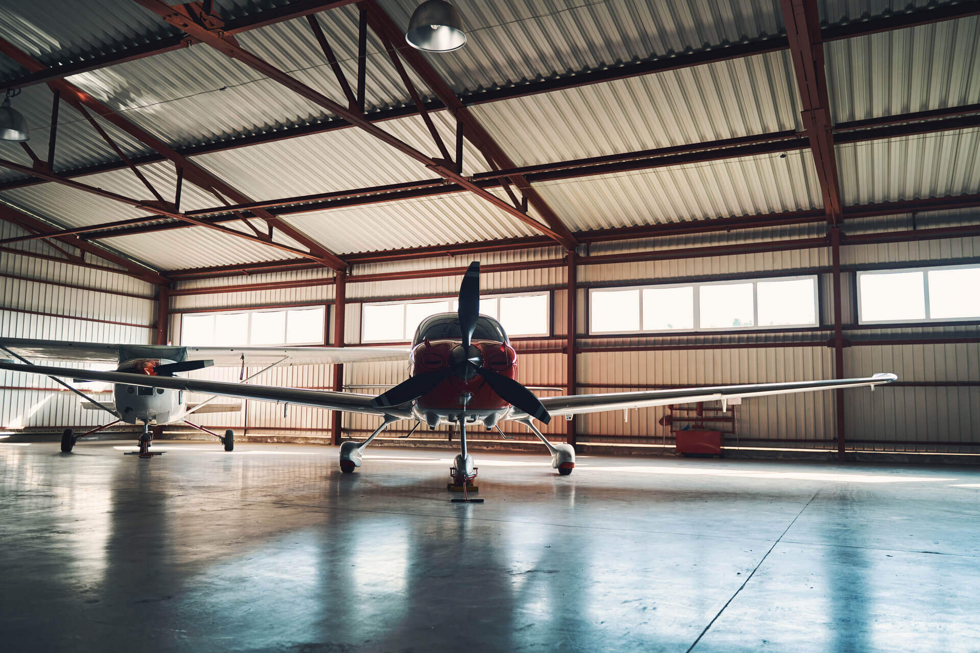 airport-parking-building-with-two-light-aircrafts-2024-10-21-15-25-14-utc (1) (1)