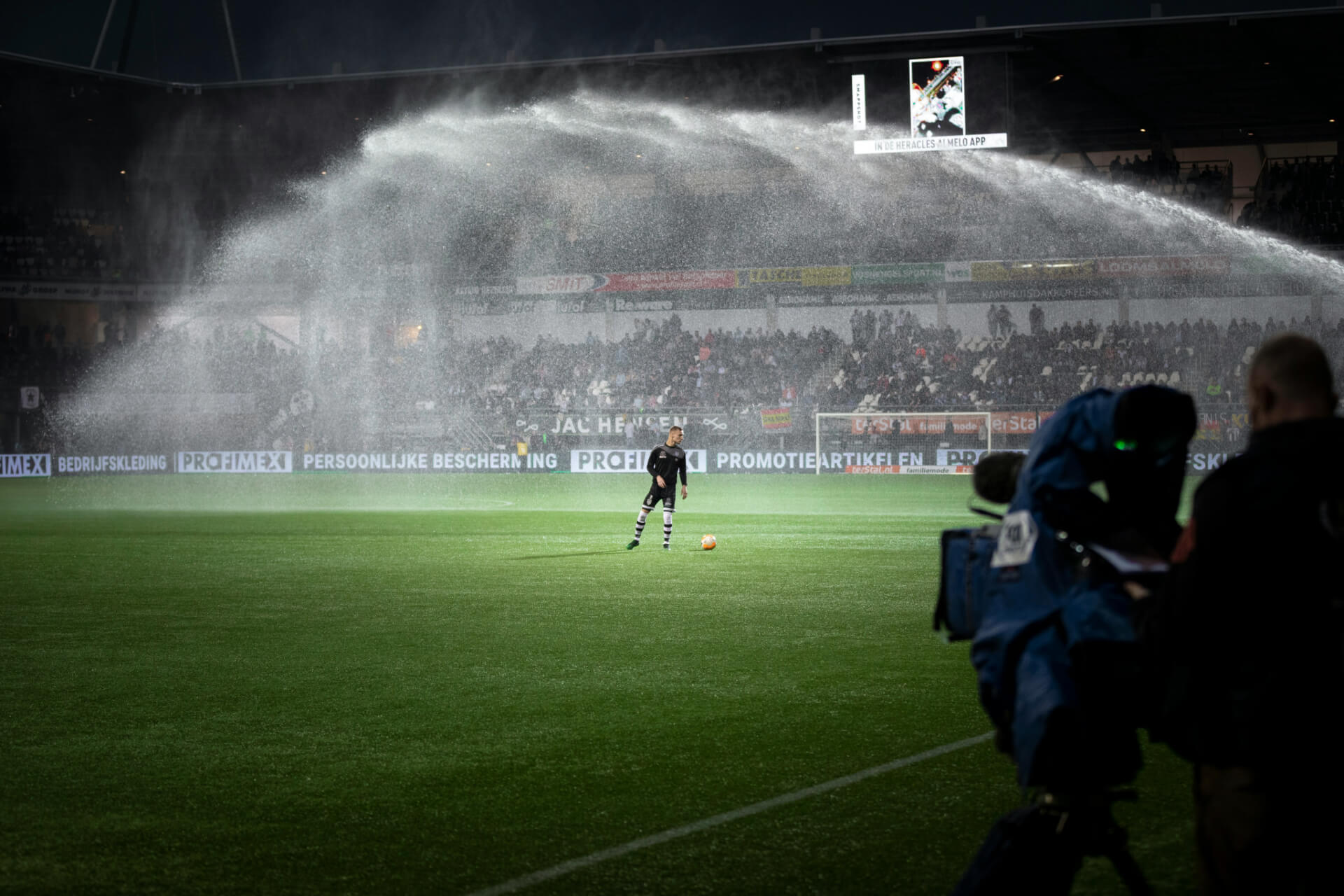soccer player lit up by led stadium lights